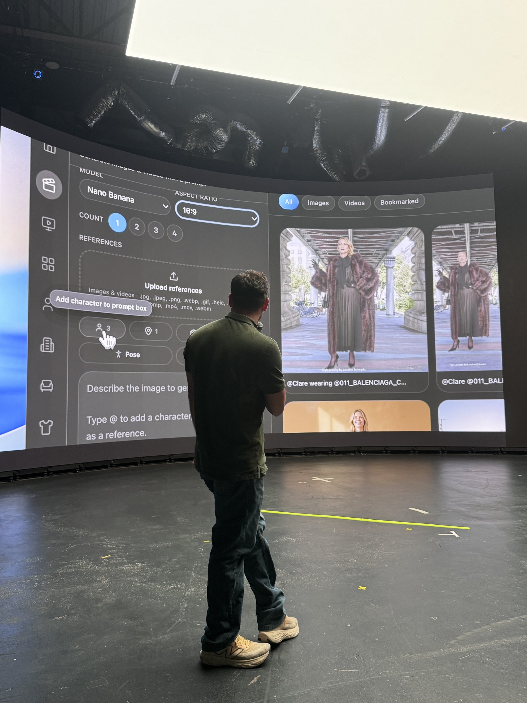 Javishth Chabria presenting on stage in front of a large curved LED volume displaying a character-reference interface.